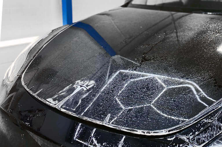 XPEL Lakkbeskyttelse SGN BASE applied on a car hood, showcasing its protective qualities against scratches and UV rays.